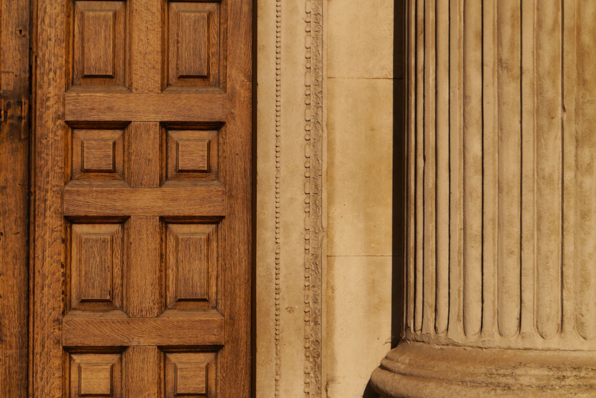 Wooden door and stone pillar close up